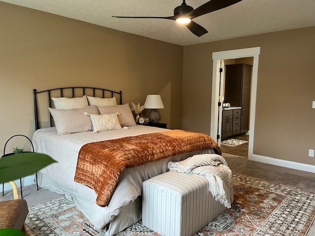 bedroom featuring a textured ceiling, ceiling fan, and ensuite bathroom