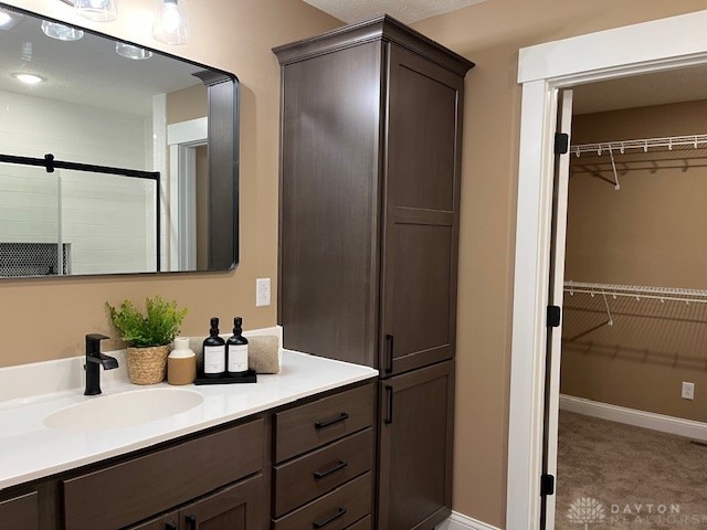 bathroom with vanity and an enclosed shower