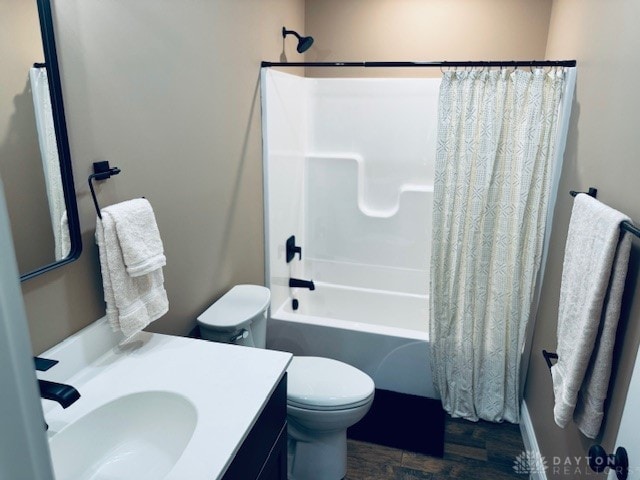 full bathroom with toilet, wood-type flooring, sink, and shower / tub combo