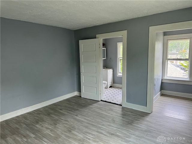 unfurnished bedroom featuring light hardwood / wood-style floors and a textured ceiling