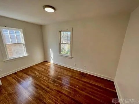 spare room featuring dark hardwood / wood-style flooring