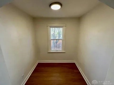 spare room featuring dark hardwood / wood-style flooring