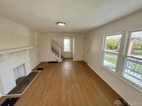 unfurnished living room featuring dark hardwood / wood-style flooring