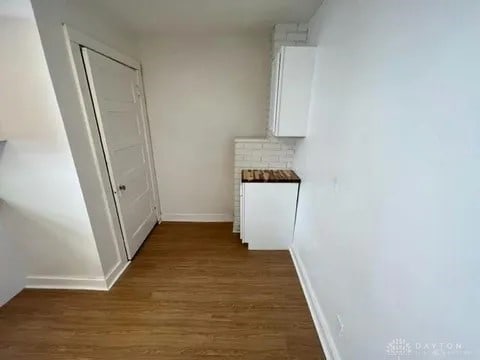 hallway with dark wood-type flooring