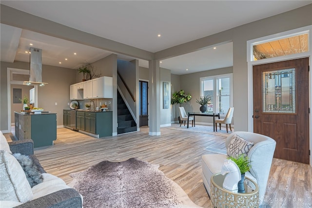 living room featuring sink and light hardwood / wood-style flooring