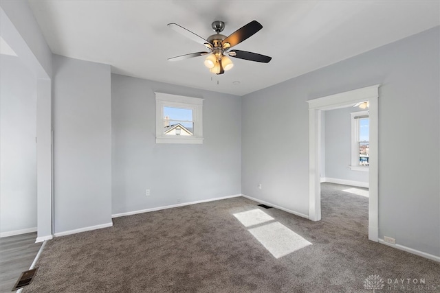 carpeted empty room featuring ceiling fan