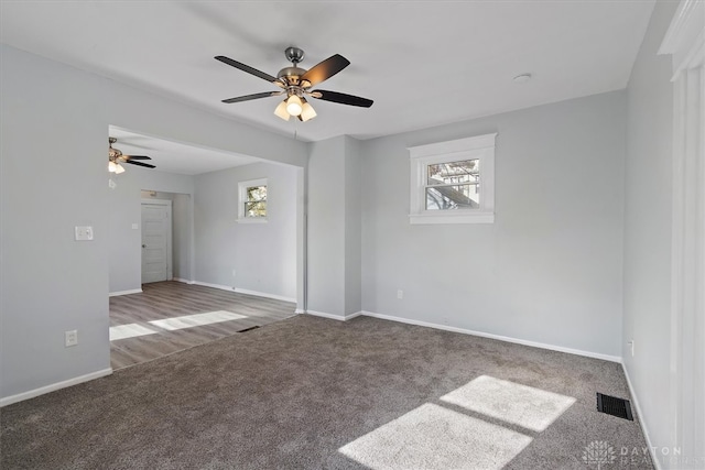 empty room with ceiling fan and carpet