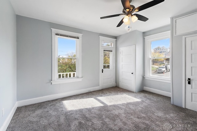 unfurnished bedroom featuring multiple windows, carpet flooring, and ceiling fan