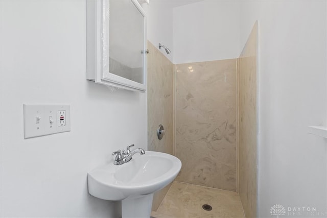 bathroom featuring sink, tile patterned floors, and a shower