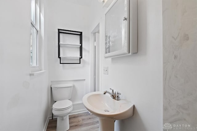 bathroom featuring hardwood / wood-style flooring, toilet, and sink