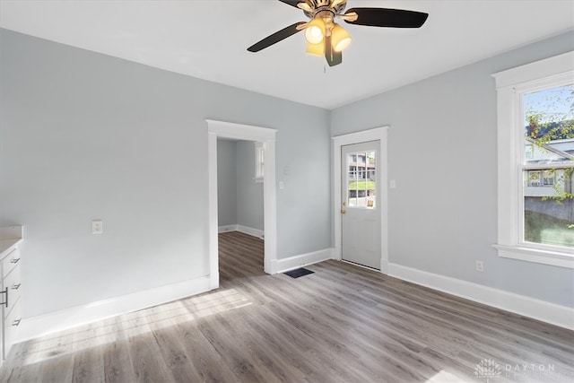 unfurnished room with ceiling fan and light hardwood / wood-style flooring