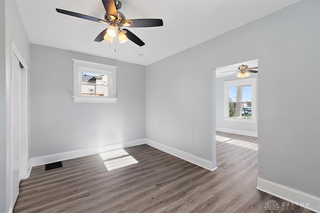 spare room featuring dark hardwood / wood-style floors and ceiling fan