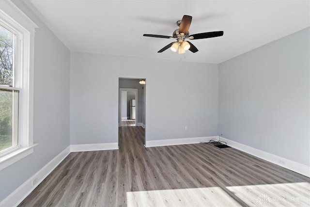 spare room with hardwood / wood-style floors and ceiling fan