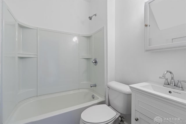 full bathroom with toilet, vanity, and shower / washtub combination