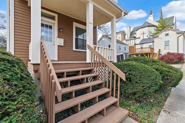 view of exterior entry with covered porch