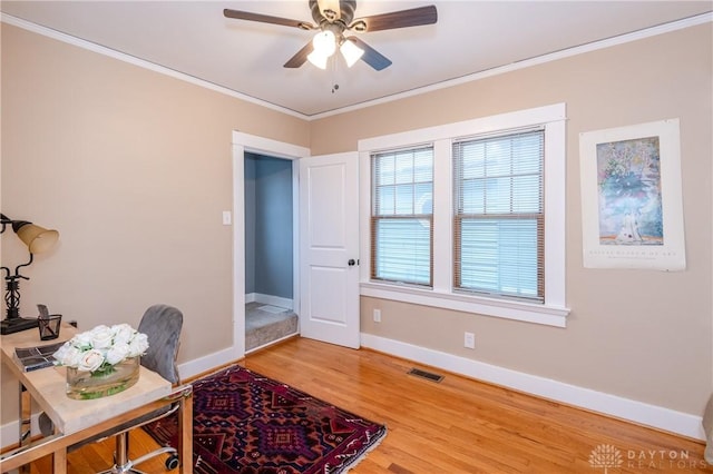 office featuring hardwood / wood-style floors, ceiling fan, and crown molding