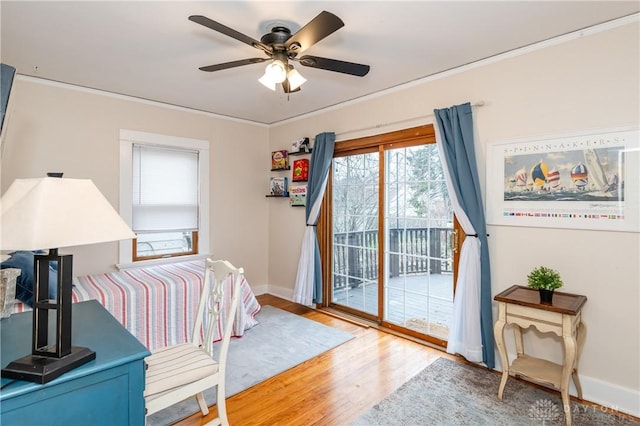 bedroom with wood-type flooring, access to outside, ceiling fan, and crown molding