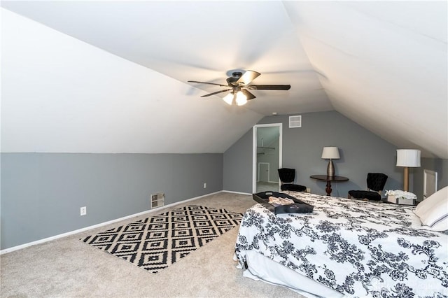 carpeted bedroom with ceiling fan and vaulted ceiling