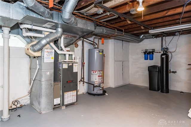 basement featuring gas water heater and heating unit