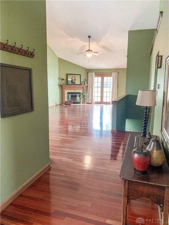 living room featuring ceiling fan, vaulted ceiling, and hardwood / wood-style flooring