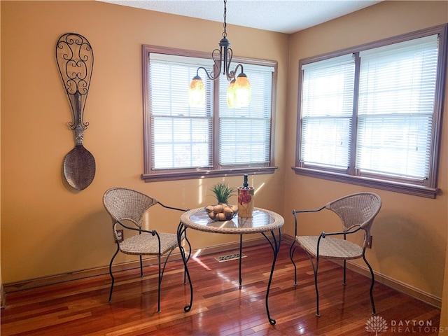 sitting room featuring a chandelier and hardwood / wood-style flooring