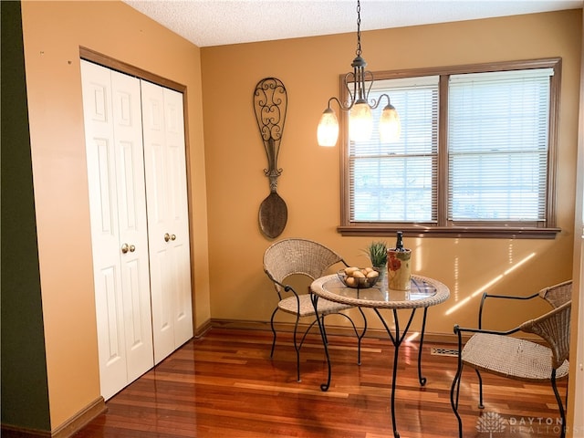 sitting room with dark wood-type flooring and a textured ceiling