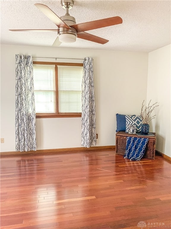 unfurnished room featuring hardwood / wood-style floors, a textured ceiling, and ceiling fan