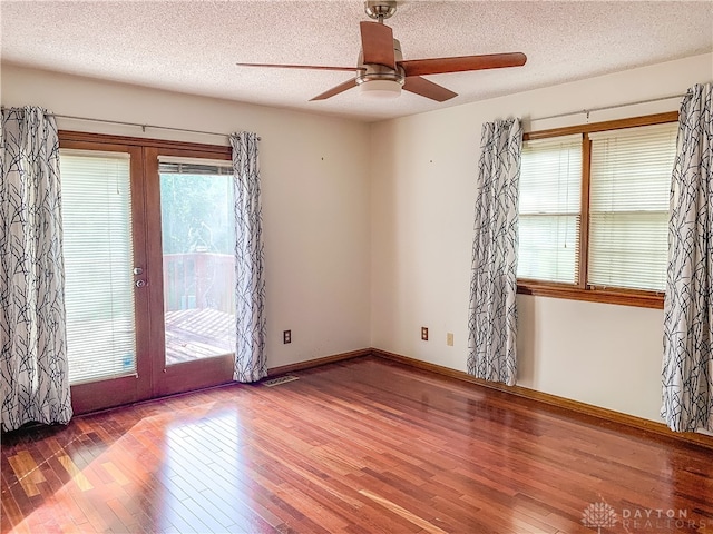 spare room featuring french doors, a textured ceiling, ceiling fan, and hardwood / wood-style floors