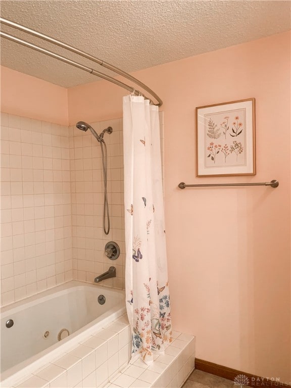 bathroom with a shower with shower curtain and a textured ceiling