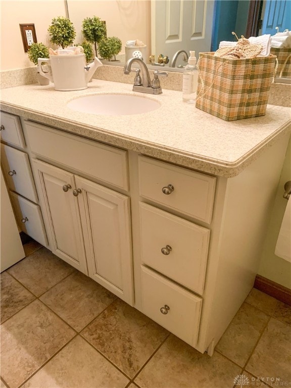 bathroom with tile patterned floors and vanity