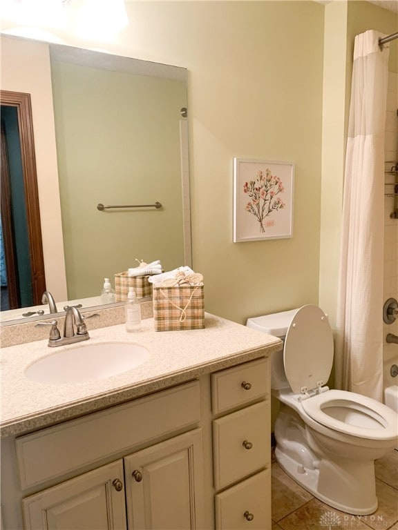 full bathroom featuring toilet, shower / tub combo, vanity, and tile patterned floors