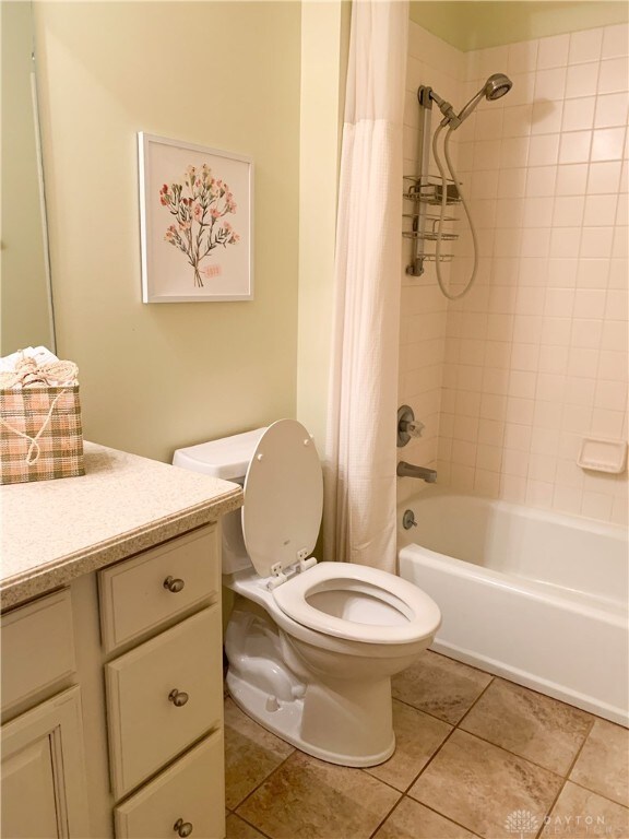 full bathroom with tile patterned flooring, vanity, toilet, and shower / tub combo