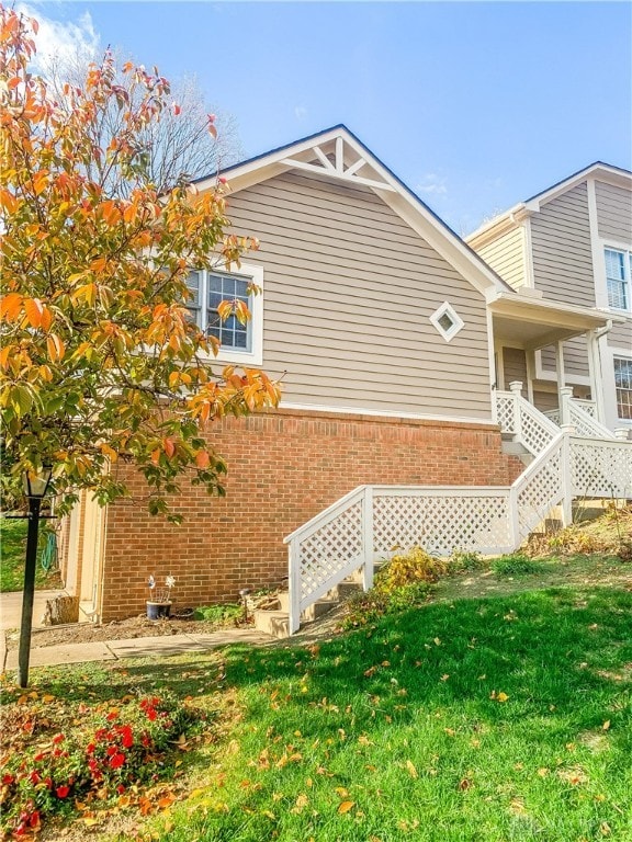 view of side of home with a yard