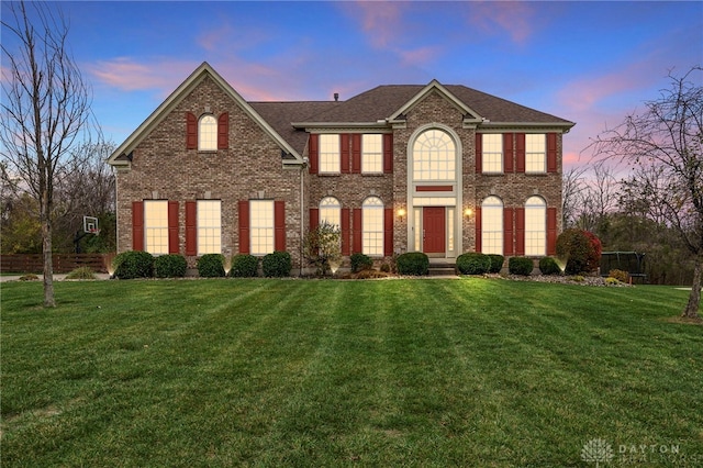 colonial-style house with a yard