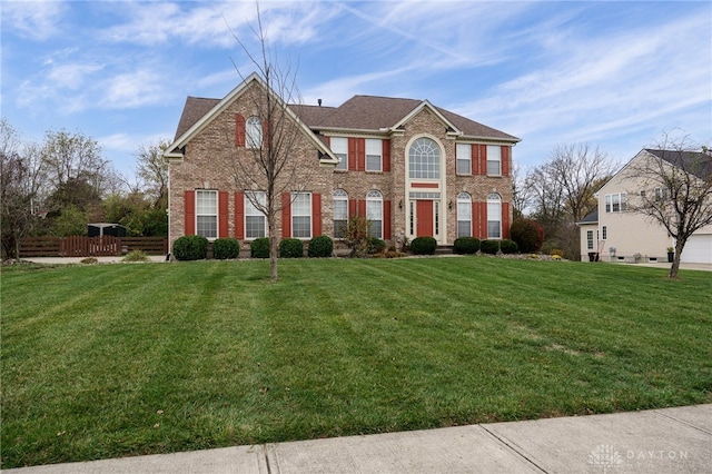 colonial inspired home with a front lawn