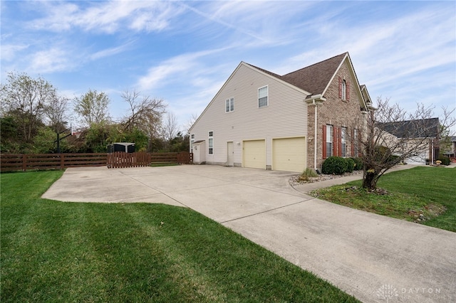 view of home's exterior featuring a lawn and a garage