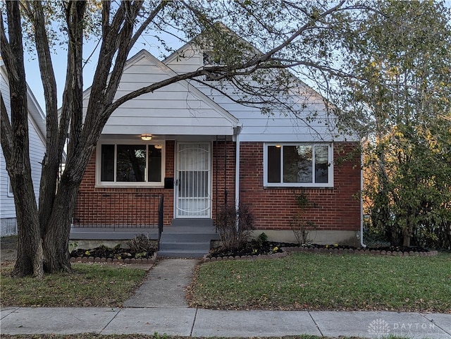 bungalow-style house with a front lawn