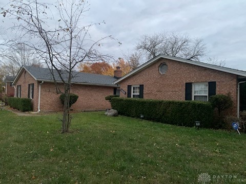 view of side of property with a yard