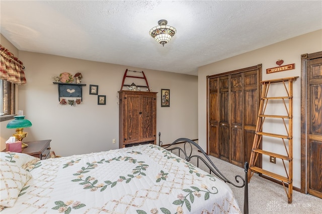 carpeted bedroom featuring a textured ceiling and a closet