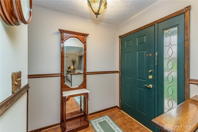 entrance foyer with light wood-type flooring and a textured ceiling