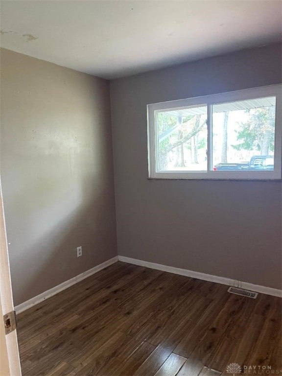 empty room featuring dark hardwood / wood-style flooring