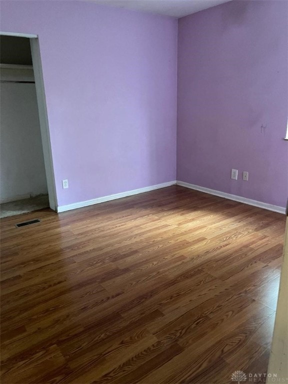 unfurnished bedroom featuring dark hardwood / wood-style floors