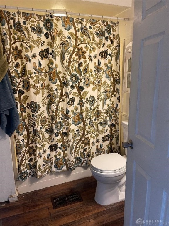 bathroom featuring hardwood / wood-style floors and toilet