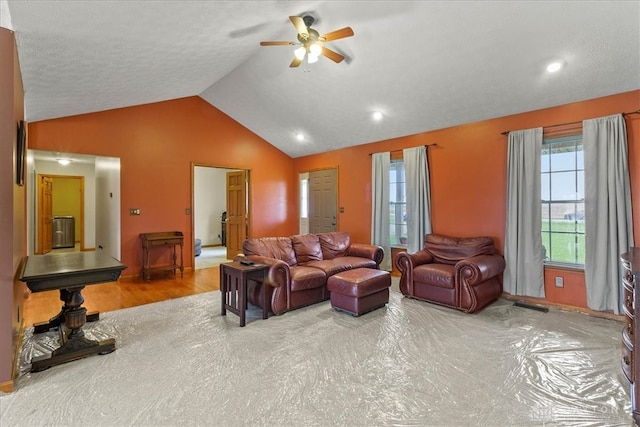 living room featuring a textured ceiling, ceiling fan, hardwood / wood-style floors, and vaulted ceiling