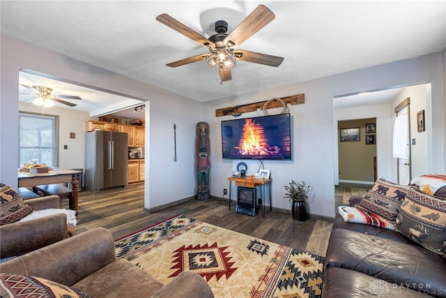 living room with ceiling fan and dark hardwood / wood-style floors