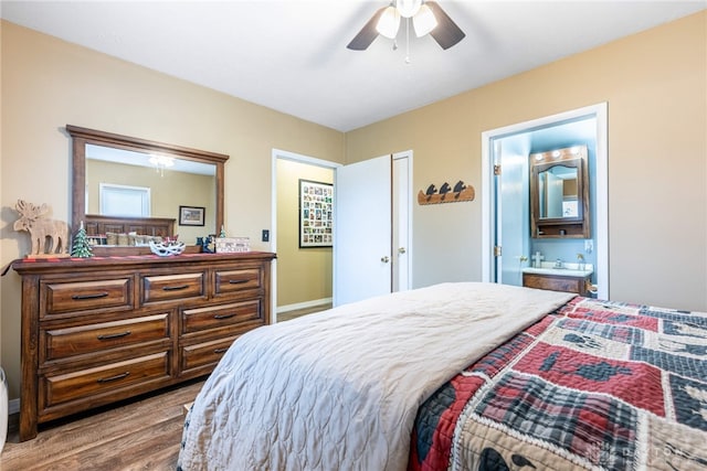 bedroom featuring connected bathroom, light hardwood / wood-style flooring, and ceiling fan