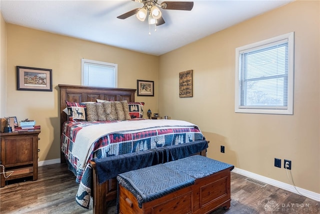 bedroom with ceiling fan and dark hardwood / wood-style floors