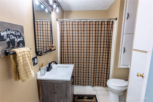 bathroom with vanity, toilet, walk in shower, tile patterned flooring, and a textured ceiling