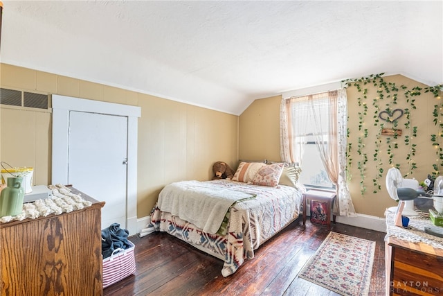 bedroom featuring vaulted ceiling and dark hardwood / wood-style flooring