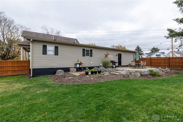 rear view of house with a yard and a patio